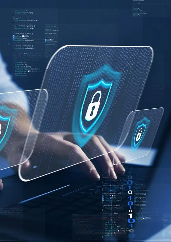 Digital security shields appear while user types on a futuristic laptop.